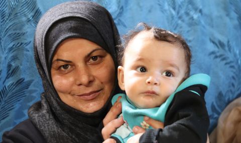 Safaa, a mother of three, with her eight-month-old son, Hudhayfa