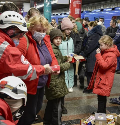 Ukrainian Red Cross staff providing food and basic necessities to people sheltering in a subway station in Kyiv, Ukraine