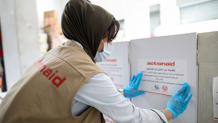 Volunteers distribute emergency supplies for those affected by the coronavirus crisis in the Occupied Palestinian Territory