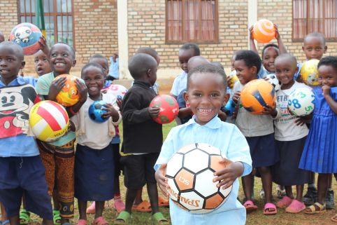 In southern Rwanda, 60 children at a local early learning centre receive 26 balls from ActionAid's child sponsorship gift fund