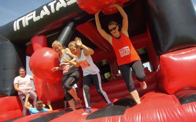 Runners on an inflatable obstacle course